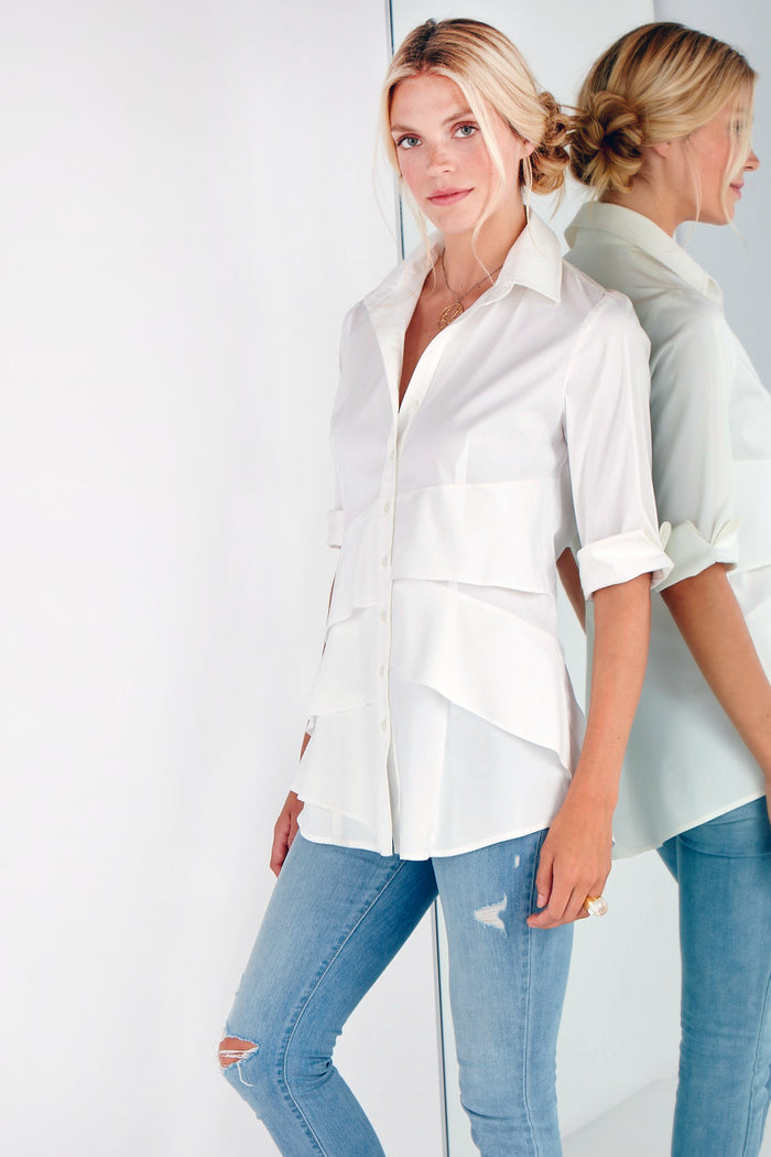 A blonde fashion model wearing Finley Jenna dress, a white button-down shirtdress with bias flounce accents and a relaxed fit.