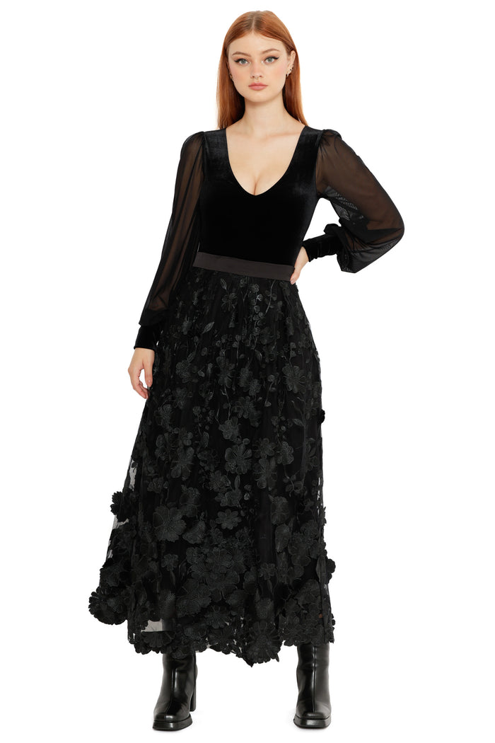 Model wearing the Altered Colour Lace Maxi Skirt, a black gothic maxi skirt featuring sheer lace fabric, floral appliqué detailing and a flowing romantic silhouette