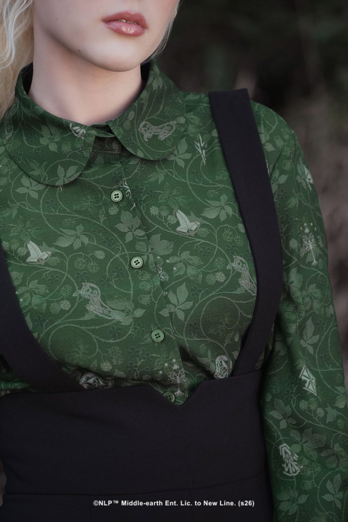 Close-up campaign shot of the Bag End Wallpaper Long Sleeve Blouse by BlackMilk, showing the buttoned Peter Pan collar and hobbit-hole wallpaper print in deep green.