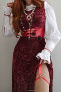 Model wearing the Be With Me Always Black Cherry Burned Velvet Princess Maxi Dress from the Wuthering Heights collection, featuring rich red velvet floral texture, fitted bodice and dramatic thigh split