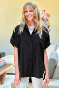 Woman wearing a black shirt in a living room setting