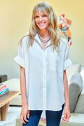 Woman wearing a white blouse in a living room setting