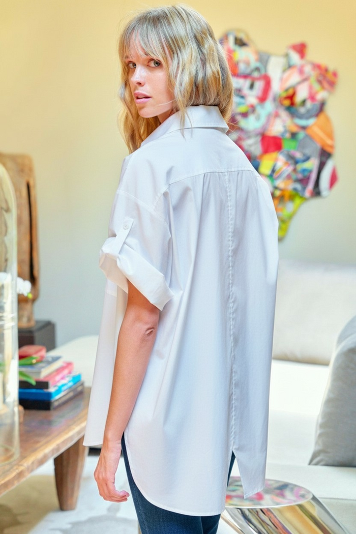 Woman wearing a light blue shirt in a living room setting