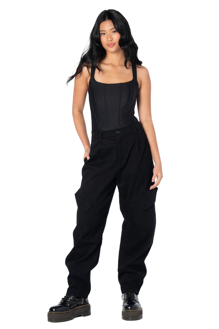 Black barrel leg cargo pants featuring a relaxed silhouette, oversized utility pockets, stretch cotton fabric and seam panel detailing for comfortable everyday streetwear and alternative fashion.