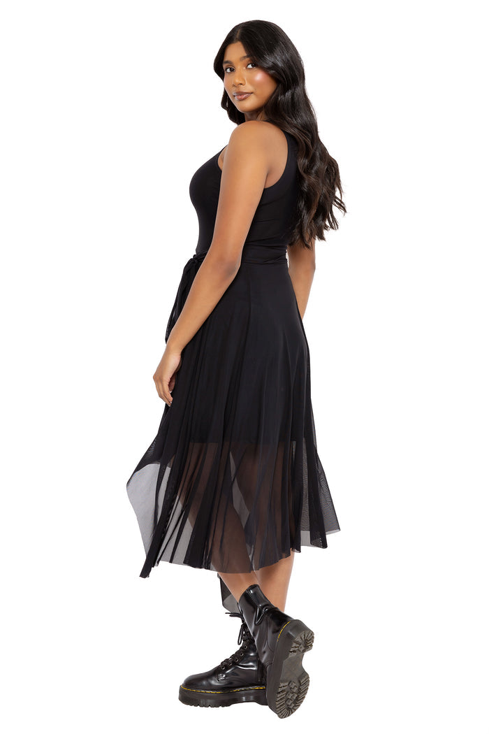 Gothic black midi dress with a floaty asymmetric mesh hem and fitted bodice designed for effortless dark academia styling. This corporate goth dress blends whimsigoth and alternative fashion aesthetics with a romantic flowing silhouette.