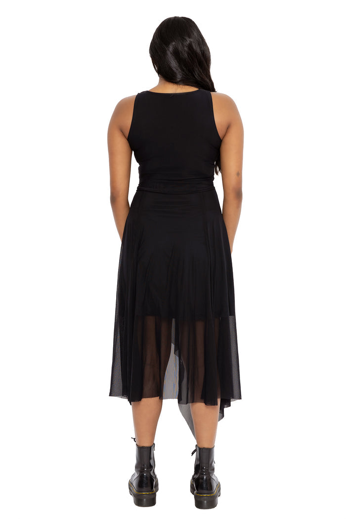 Minimalist witchcore dress featuring sheer black mesh layers, a cinched waist tie and dramatic handkerchief hemline. This alternative goth dress combines dark fairycore and modern pagan aesthetics with elegant all-black styling.