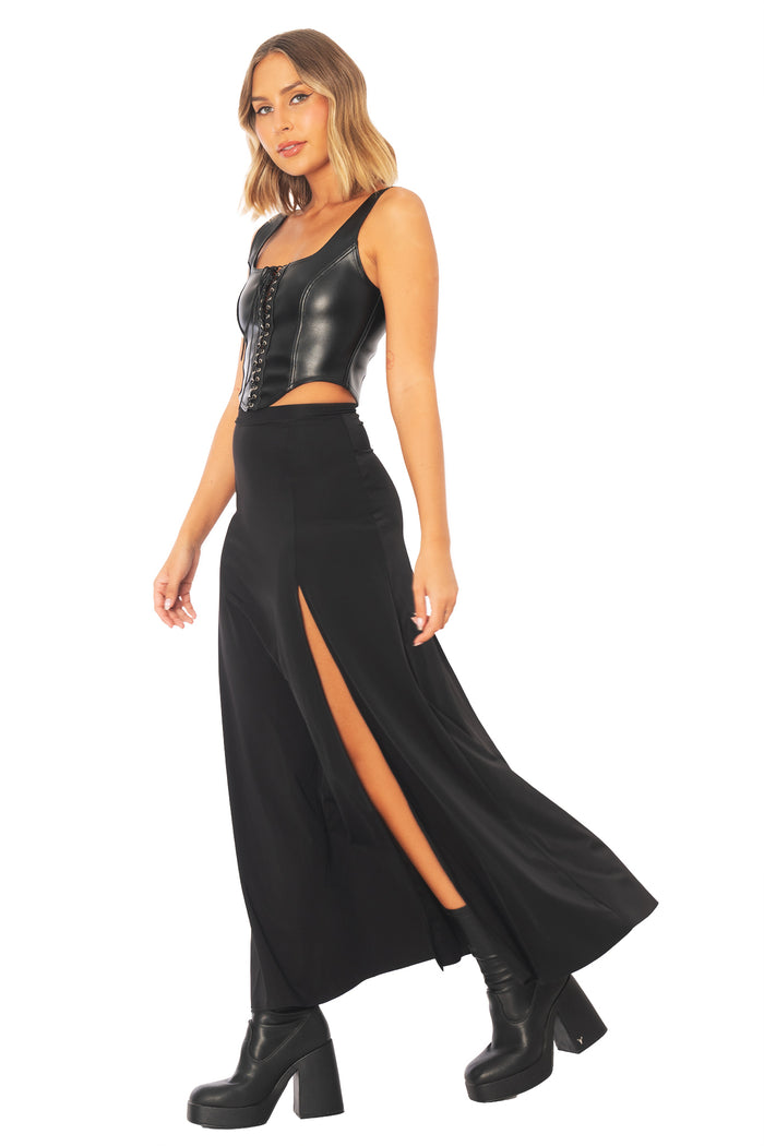 Versatile black stretch maxi skirt with thigh split, featuring a flattering fitted silhouette that pairs effortlessly with blouses, knitwear and tops for office wear, corporate fashion, travel and evening outfits.