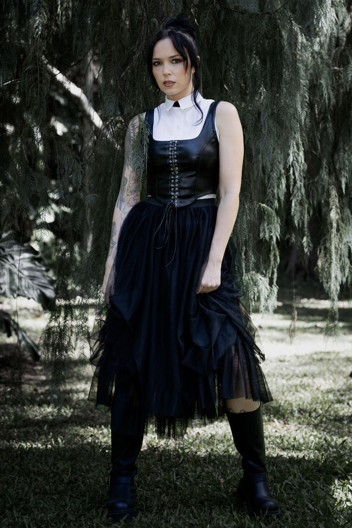 Gothic black tulle skirt featuring layered mesh fabric, a floaty midi silhouette and romantic ballerina inspired movement. Perfect for corporate goth, fantasy witch and dark academia outfits, this alternative skirt adds dramatic witchcore energy to any look.