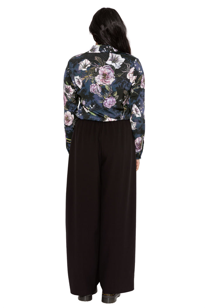 Dark academia button-up shirt with moody floral artwork and subtle hidden insects woven through a gothic botanical print. This corporate goth top combines alternative office fashion and modern witch aesthetics with a relaxed silhouette and fitted sleeves.