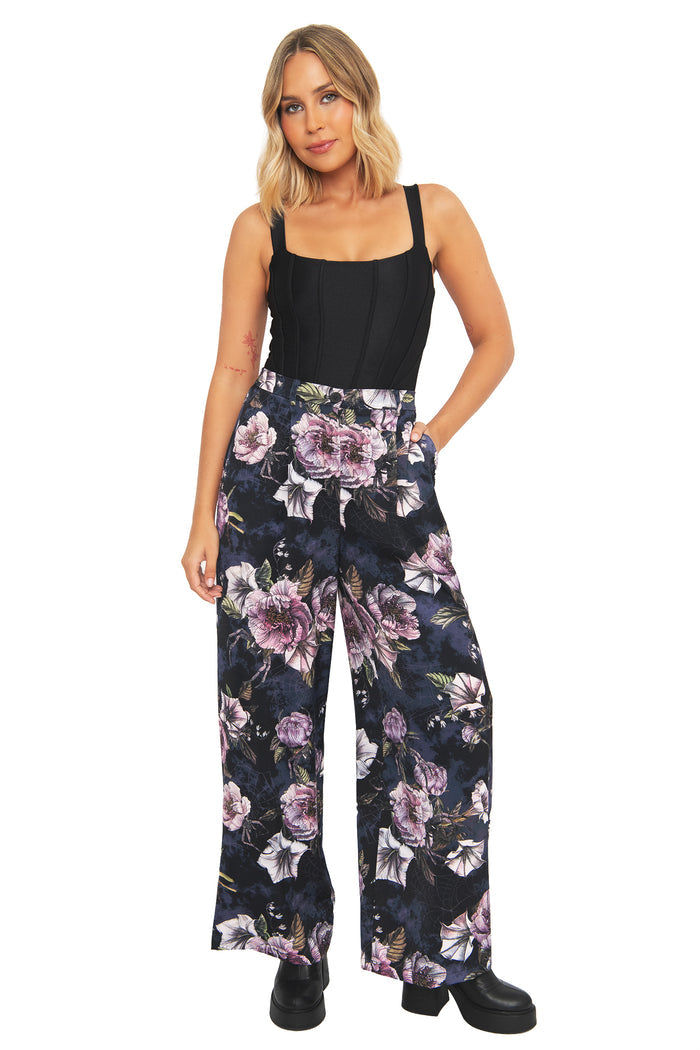Whimsigoth high waisted pants with dark floral artwork and hidden spider details layered through moody botanical textures. These alternative goth trousers blend dark fairycore and corporate witch fashion with elegant flowing movement.
