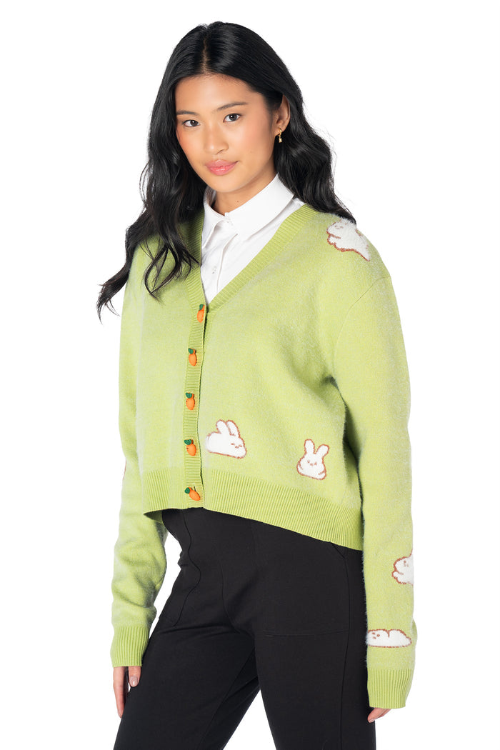 Cropped bunny cardigan crafted from soft knitted yarn with adorable rabbit artwork, carrot-shaped buttons and a relaxed fit for cosy everyday wear.