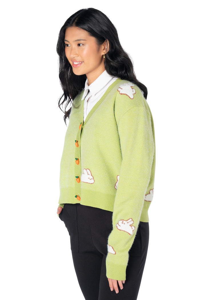 Green knitted cardigan featuring fluffy bunny motifs, novelty carrot buttons and a cropped relaxed silhouette, perfect for kawaii fashion, cottagecore outfits and animal lovers.