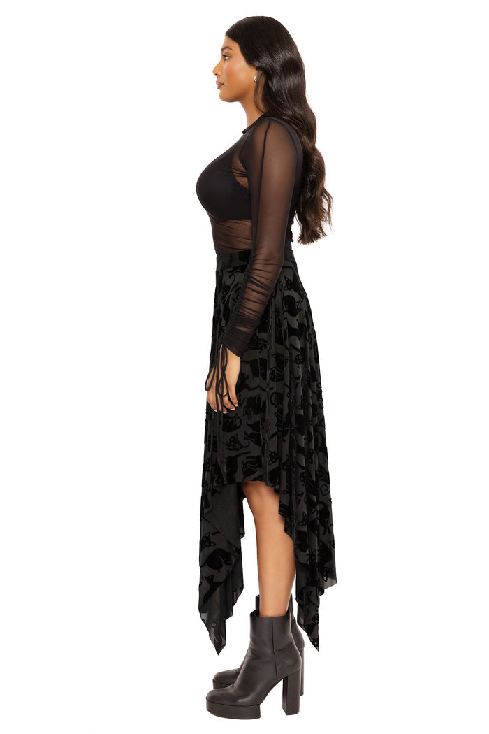 Alternative black velvet skirt with cat print and handkerchief hem, designed to add movement and texture to gothic outfits, festival fashion, spooky season looks and everyday alternative style.