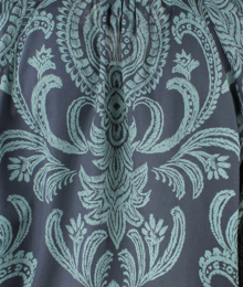 Close-up of a patterned fabric with intricate design on a dark background