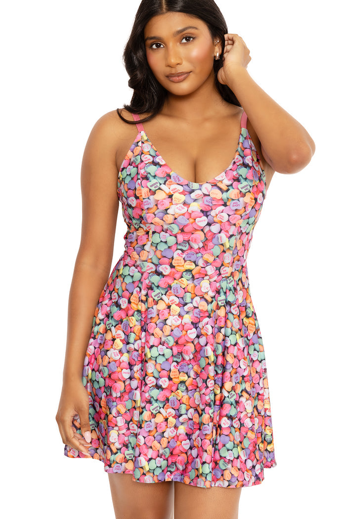Candy heart print mini strappy dress designed with a fun colourful pattern and flattering shape for casual outfits, summer events and day-to-night wear.