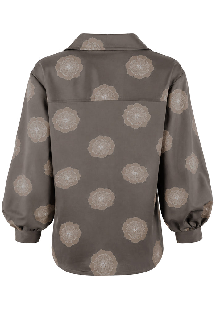 A long-sleeve button-up shirt shown from the back, featuring a dark brown base with a repeating beige floral mandala pattern.