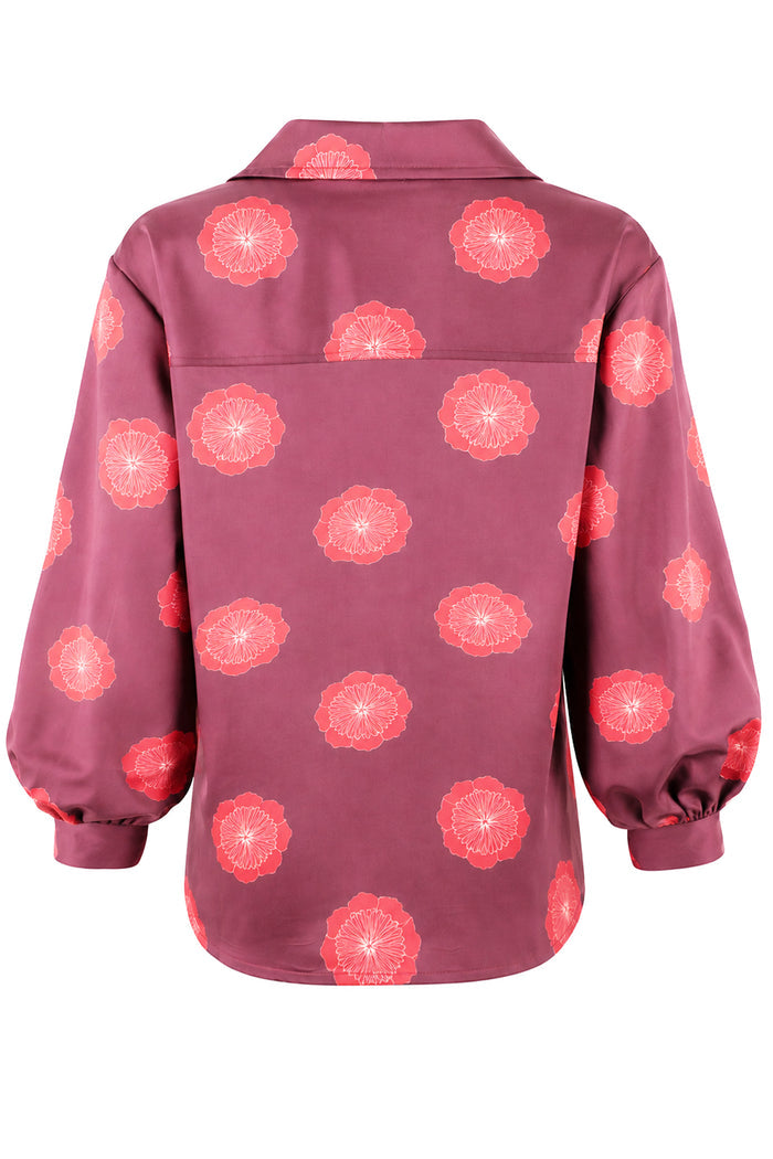 A long-sleeve button-up shirt with a collar, featuring a dusty rose base color with a repeating coral-pink floral pattern, shown against a plain white background.