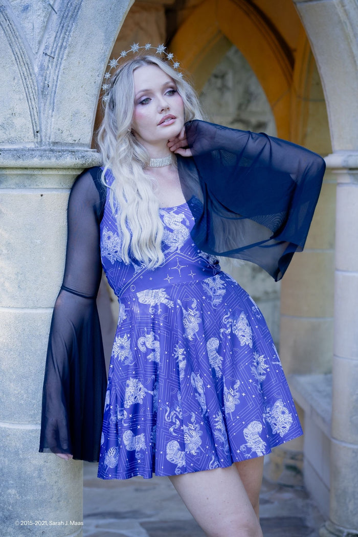 A Court of Thorns and Roses Court of Dreams dress, ACOTAR inspired scoop skater dress by Sarah J Maas with moon, stars and creature motifs, midnight print, scoop neckline and flared skirt, Night Court aesthetic
