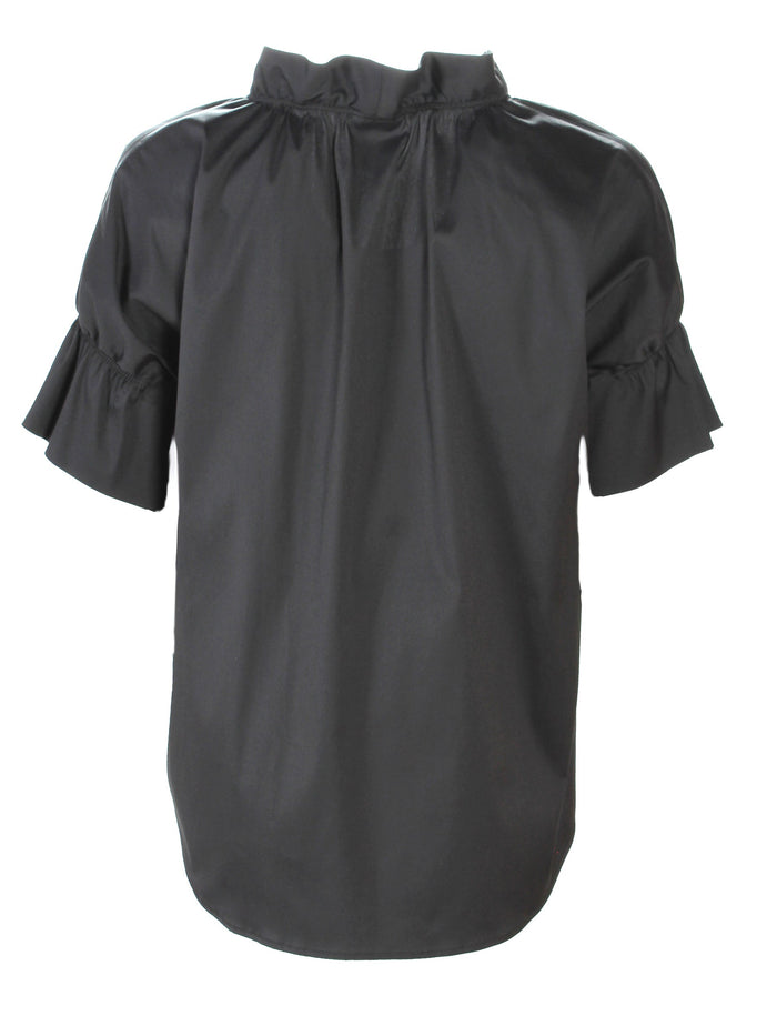 A profile view of the Finley Crosby shirt, a black poplin blouse with a ruffle collar and French sleeve detail.