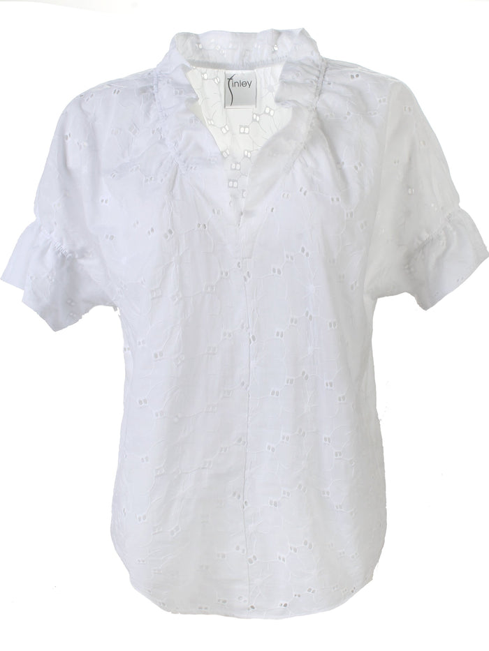 A blonde fashion model wearing the Finley Crosby shirt, a white cotton popover blouse with eyelet design.