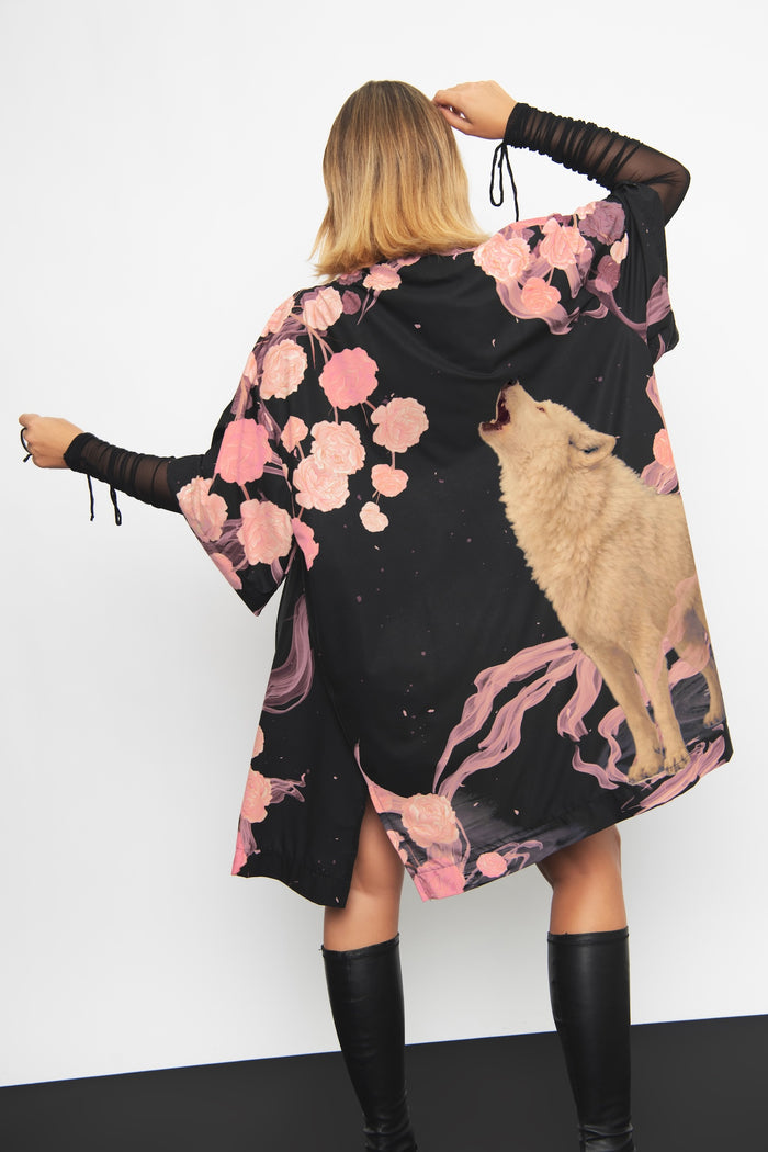 Crying at the Moon Robe featuring a wolf howling beneath the moon, designed with a flowing silhouette and comfortable fit for lounging, layering and everyday alternative fashion.