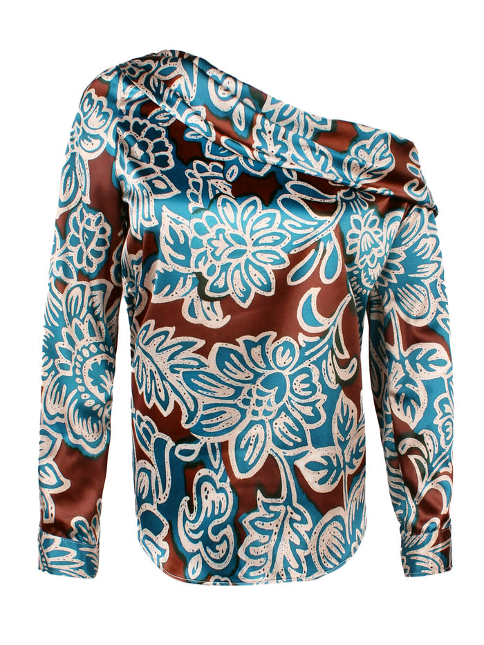 A model wearing the Finley Dani blouse, a long sleeve asymmetric satin off-shoulder top with a brown and turquoise floral print.