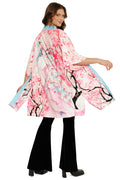 Woman wearing a pink kimono with cherry blossom design on a white background