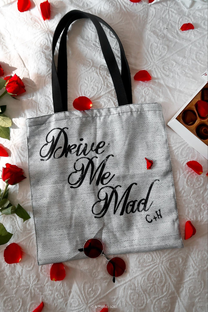 Back view of the Drive Me Mad Tote Bag from the Wuthering Heights collection, featuring handwritten gothic text artwork with BlackMilk and Wuthering Heights branding