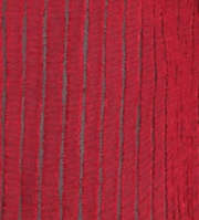 A close-up of a red textured fabric with vertical gray stripes.