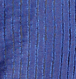A close-up of a blue textured fabric with vertical woven stripes.