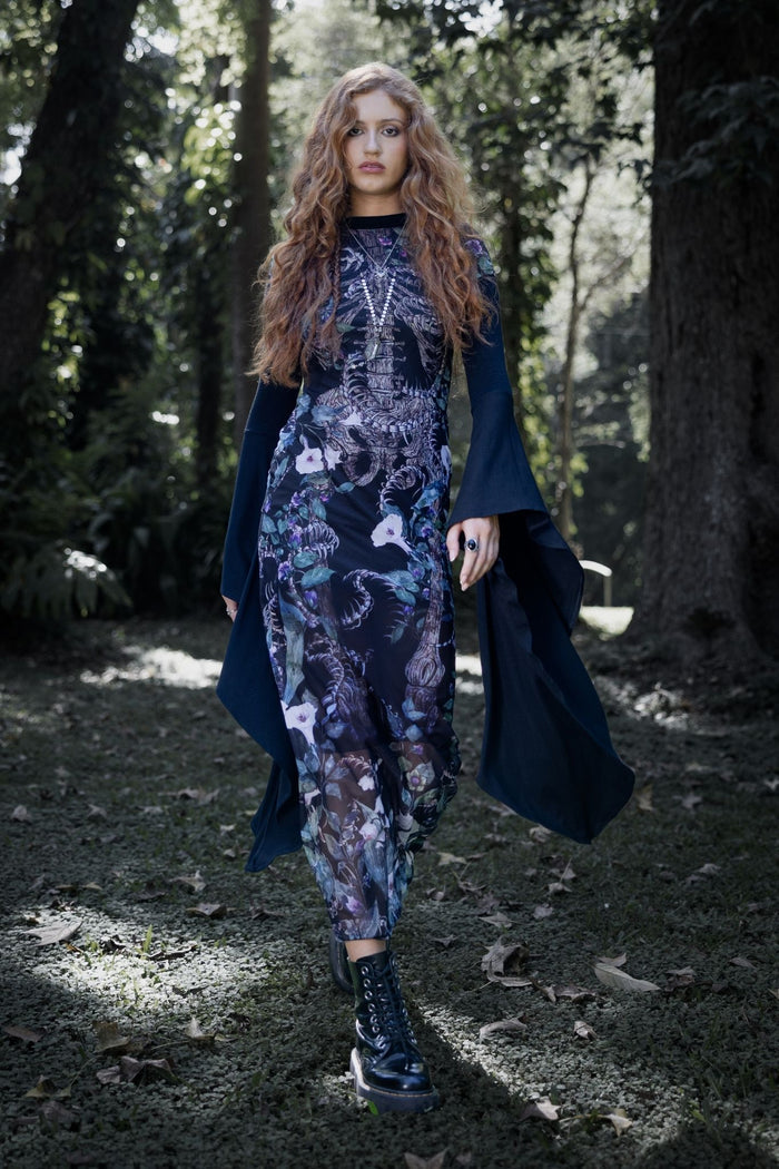 Gothic sheer mesh bodycon dress with poison floral artwork, skeletal details and creeping vines across a dark enchanted garden inspired print. This whimsigoth dress blends dark fairycore, fantasy witch and gothic fashion aesthetics with an elegant mid-calf silhouette and flattering fitted shape.