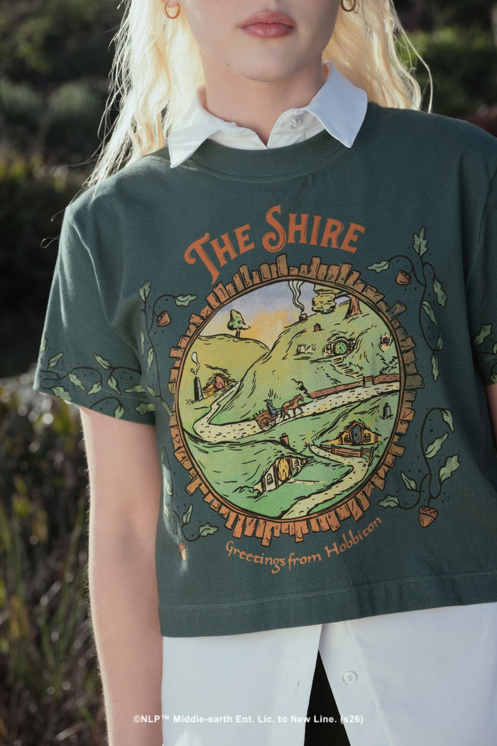 BlackMilk x The Lord of the Rings Greetings From Hobbiton Cotton Baby Tee — a pale blue cropped baby tee inspired by Bag End and the Shire, blending cottagecore whimsy with gothic streetwear.