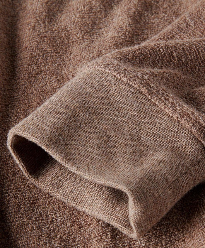Close-up of brown textured fabric with a focus on texture and color.