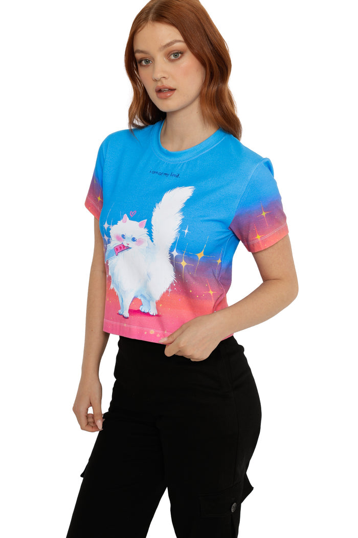 Person wearing a colorful t-shirt with a cartoon cat design on a white background