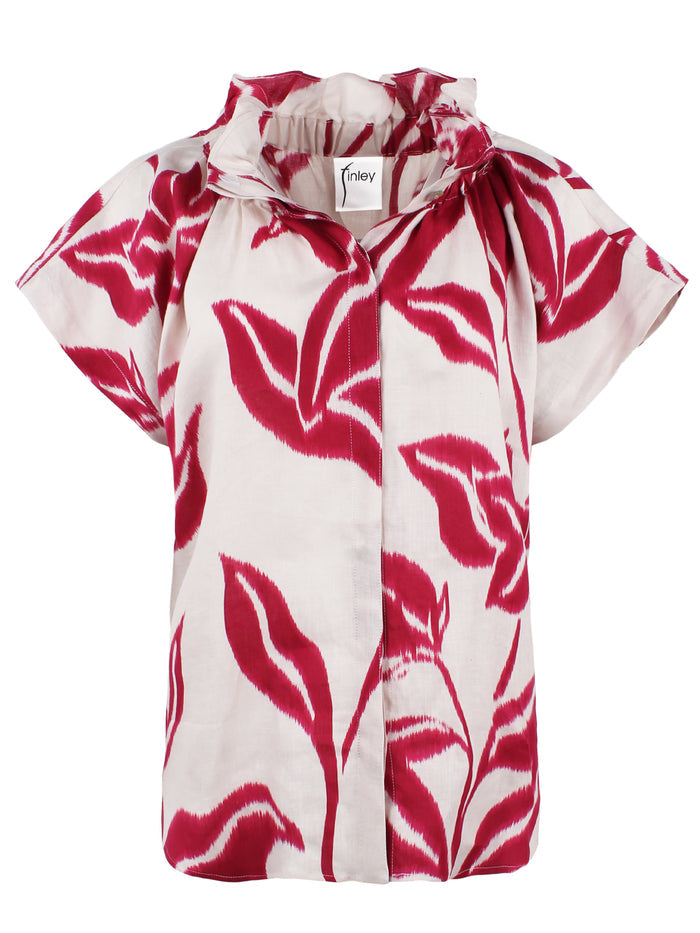 A model view of the Jenny blouse, showcasing its relaxed shape, short sleeves, and a stand collar in blue floral batik linen.