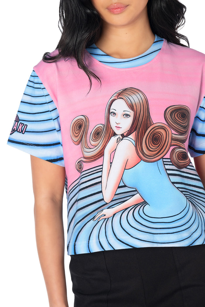 Cropped pastel graphic T-shirt featuring Kirie Goshima from Junji Ito's Uzumaki, with front and back manga artwork, official sleeve branding and a flattering baby tee fit.
