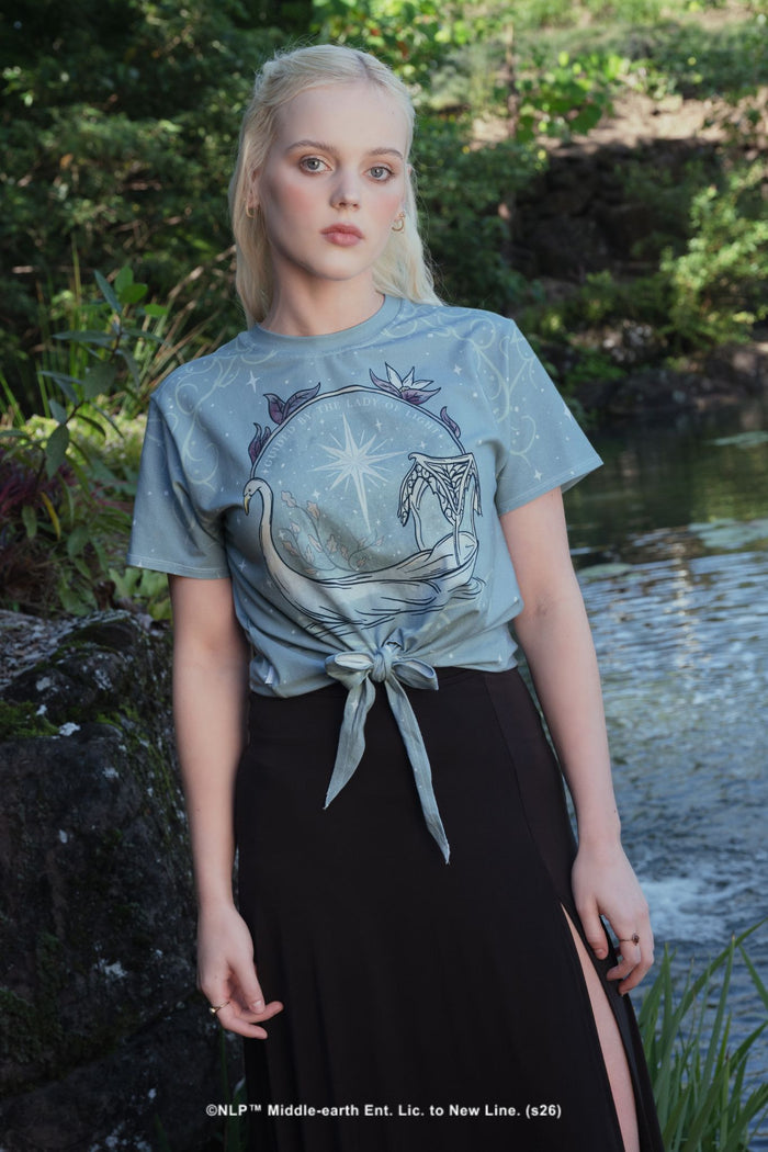 Close-up campaign shot of the Lady of Light Cotton Tie Front Tee by BlackMilk, showing the Galadriel-inspired celestial swan print in pale blue and silver.