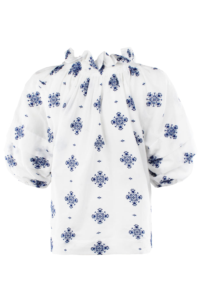 White blouse with blue floral patterns on a white background
