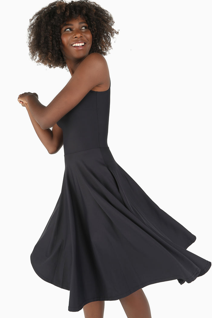 Elegant black midi dress featuring a timeless princess cut, perfect for workwear, occasion dressing, travel wardrobes and versatile styling.