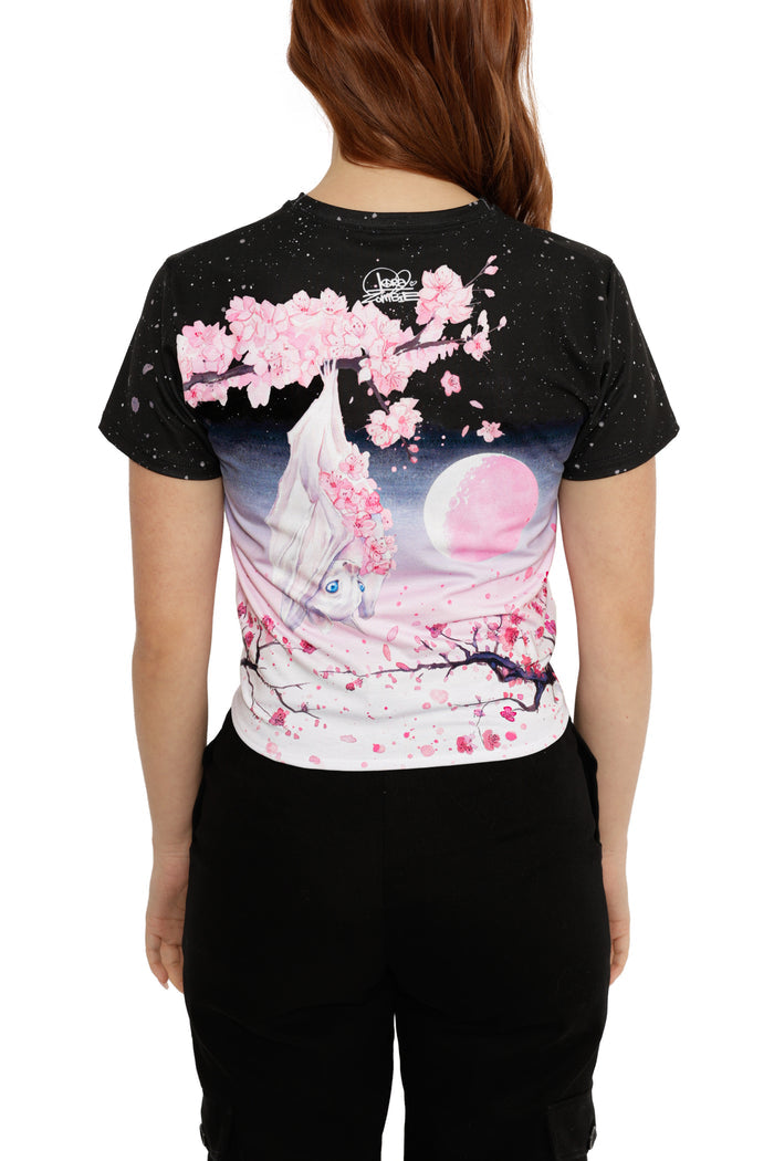 Person wearing a black t-shirt with a colorful graphic design on the back