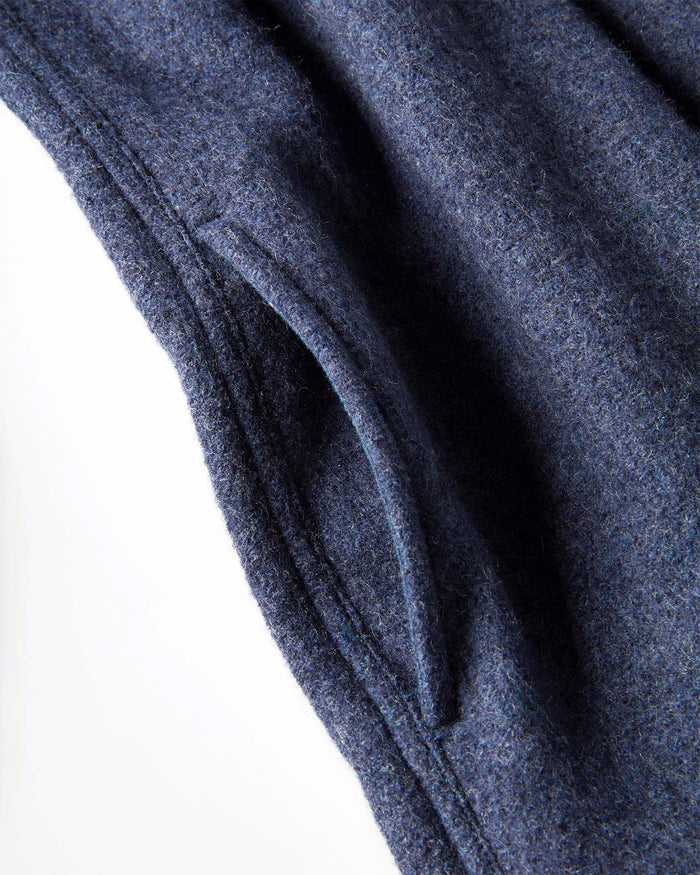 Close-up of a textured navy blue pocket on a jacket with a white background