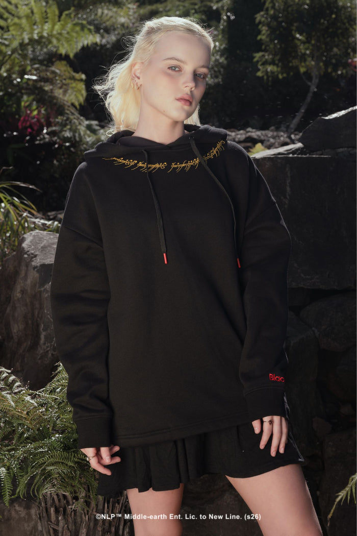 Close-up of the Black Speech inscription from the One Ring, embroidered in gold script across the neckline of this Lord of the Rings gothic streetwear hoodie by BlackMilk.