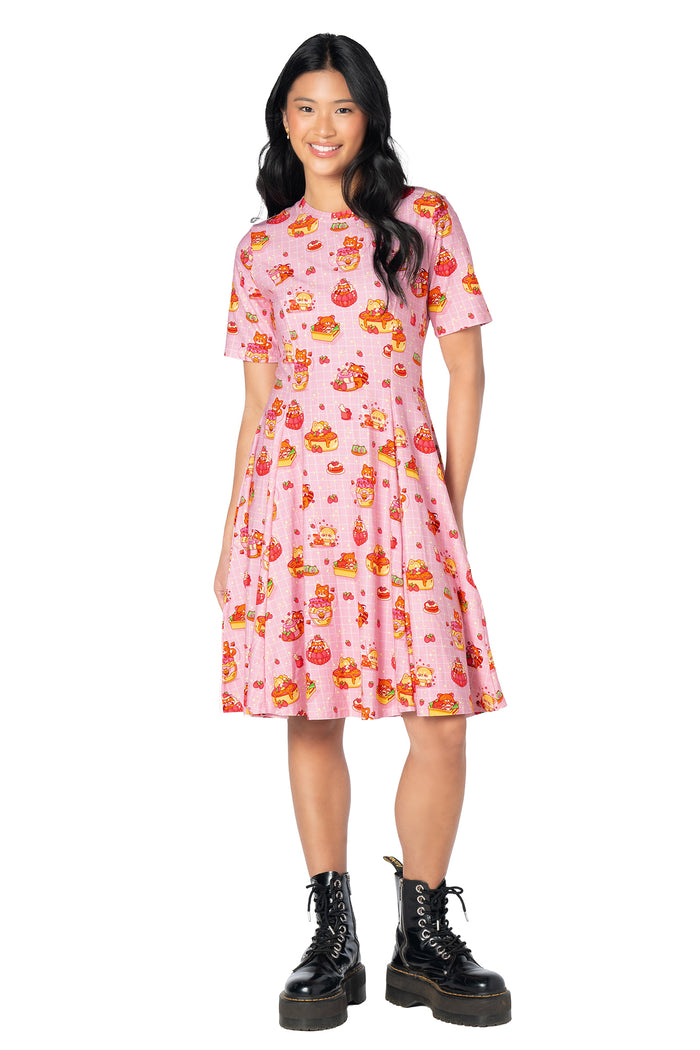 Pastel pink longline tee dress featuring an all-over bunny, strawberry, cake and dessert print with a relaxed knee-length silhouette and soft cotton-rich fabric.