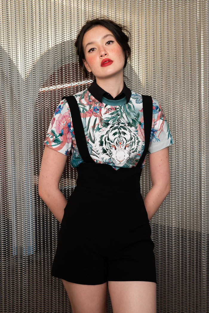 Women’s fitted baby tee featuring white tiger artwork, pastel floral print, crew neckline and cropped short sleeve silhouette