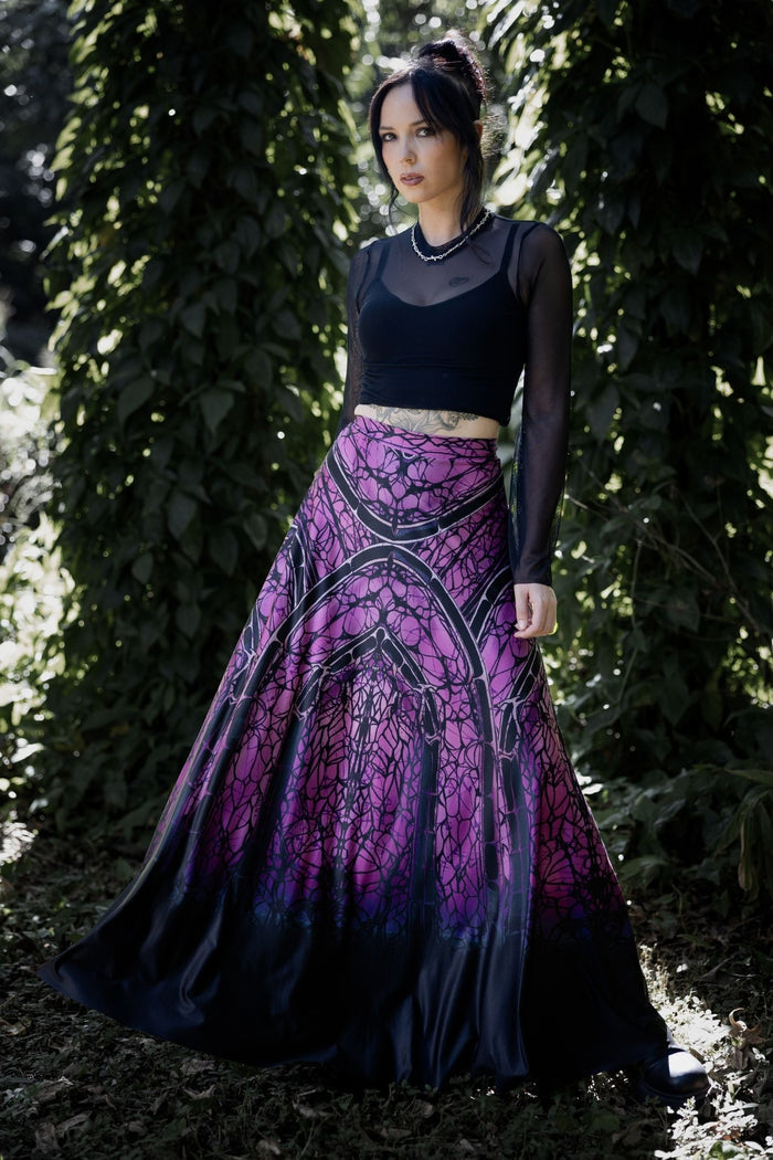Gothic maxi skirt with cathedral inspired spider web artwork in vivid purple and black tones, flowing through a dramatic full-length silhouette. This whimsigoth skirt blends dark fairycore, fantasy witch and gothic fashion aesthetics with elegant movement and haunted cathedral energy.
