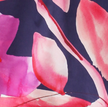 A close-up of a watercolor floral print featuring pink and magenta flower petals on a dark navy blue background.