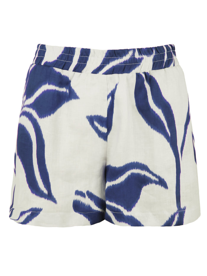 A front view of the Seaside shorts, crafted from 100% linen with a 3" inseam, side pockets, and a blue floral batik pattern.