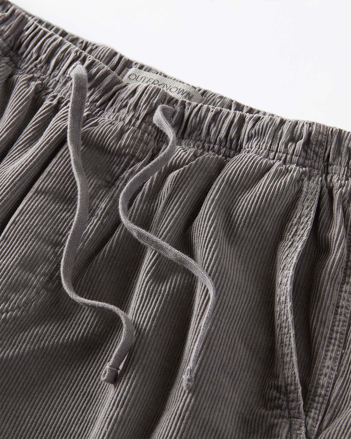 Close-up of gray corduroy pants with drawstring on a white background