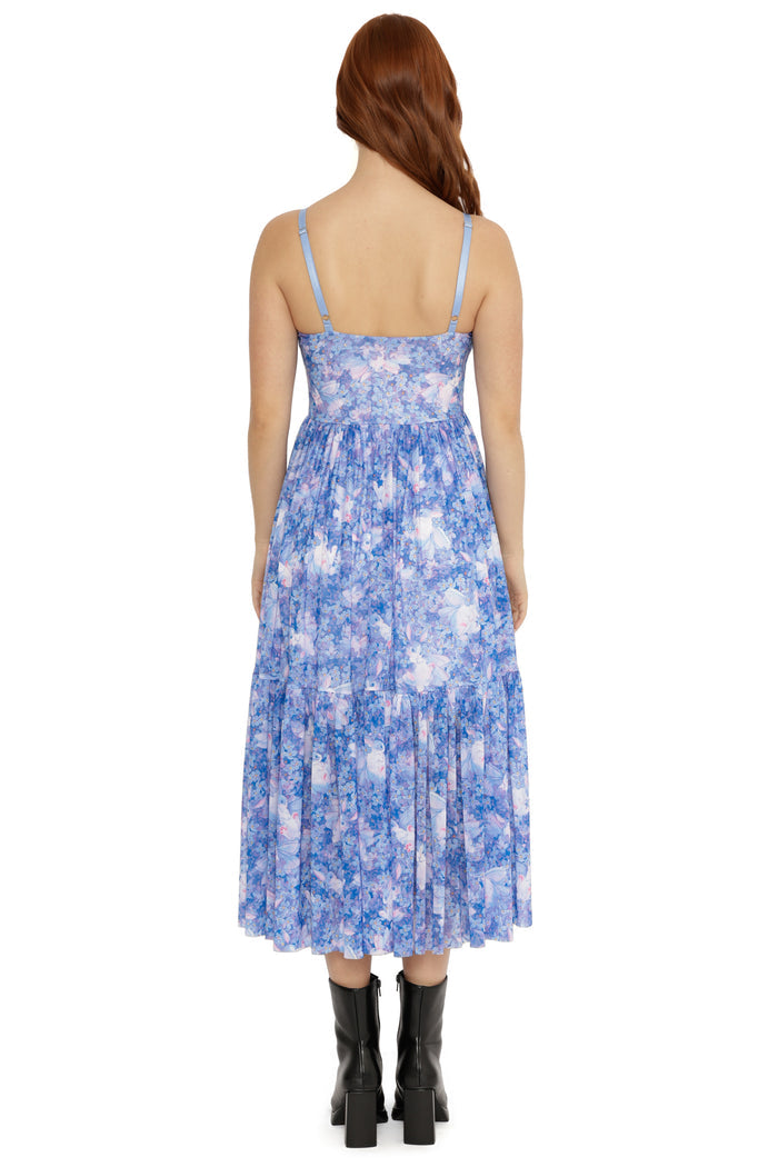 Woman wearing a blue floral dress on a white background