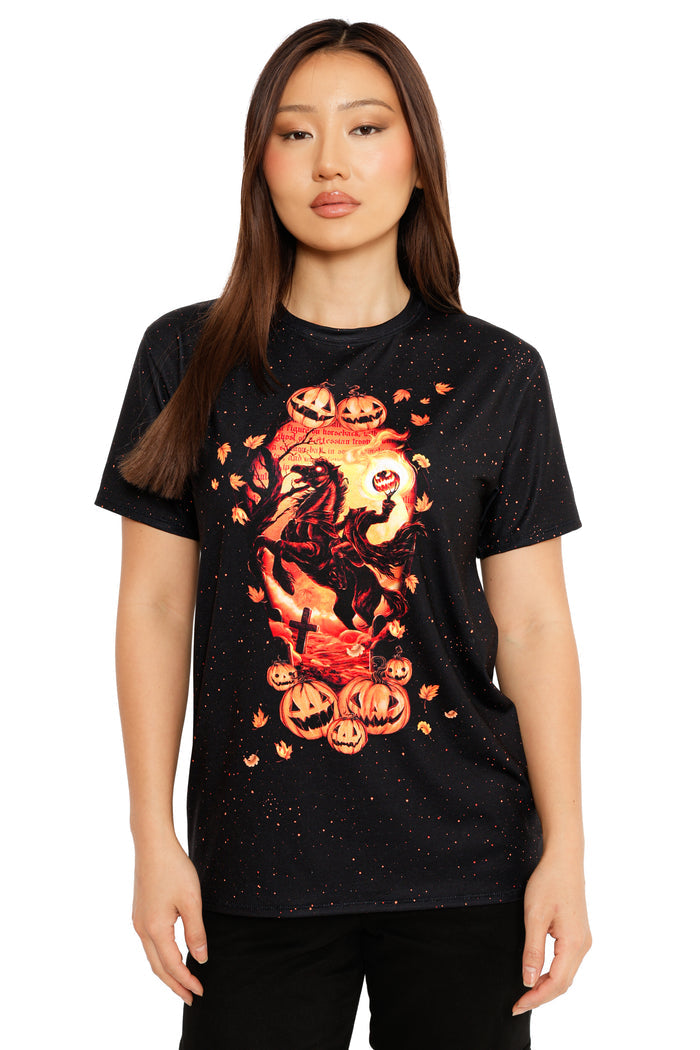 Woman wearing a black t-shirt with Halloween-themed design featuring pumpkins and a ghost.